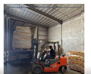 Forklift loading crate operator in PPE